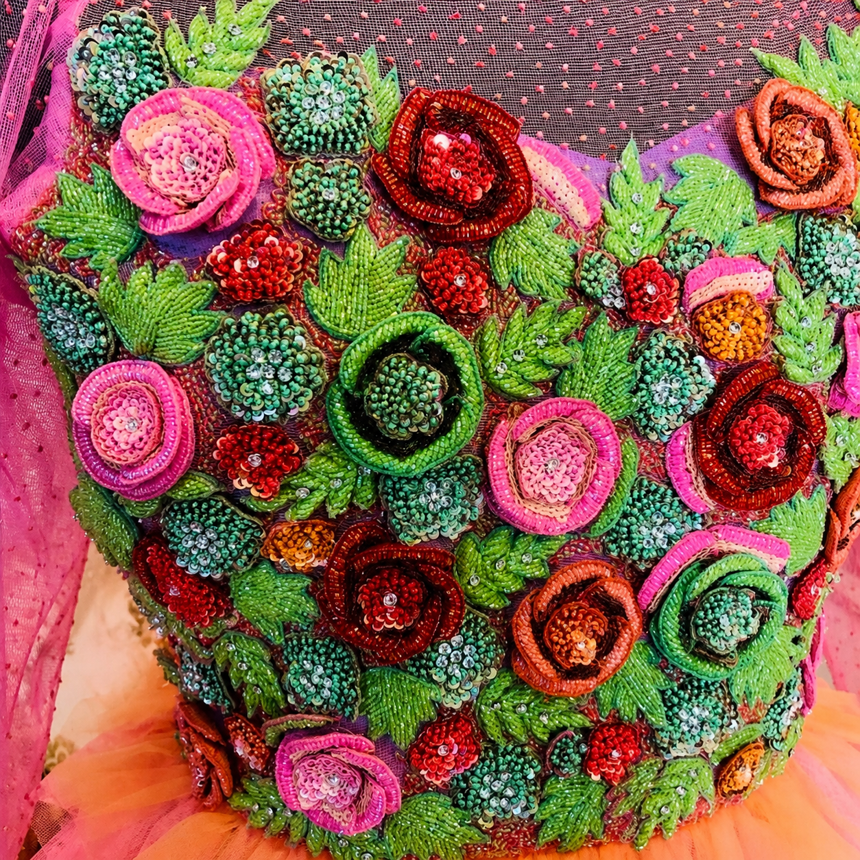 Colorful embroidered floral design on a fabric background